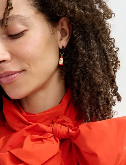 Black hoop earrings with crocodile and hot sauce pendants