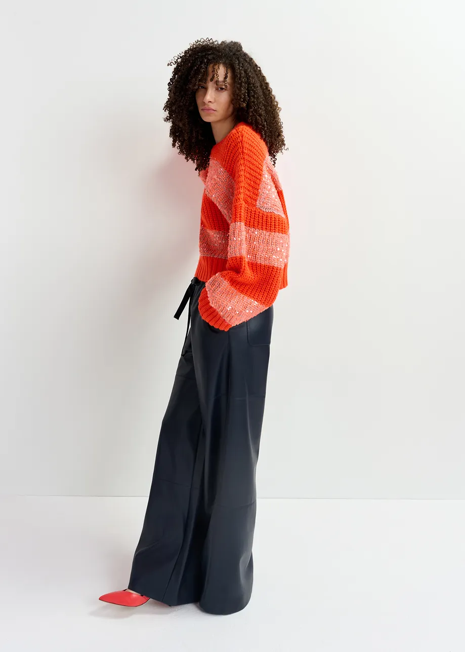 Orange knit sweater with sequin-embellished stripes