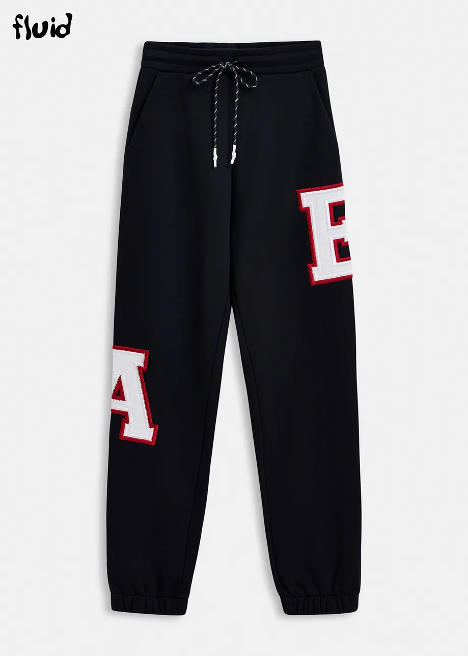 Black cotton sweatpants with embroidered patches