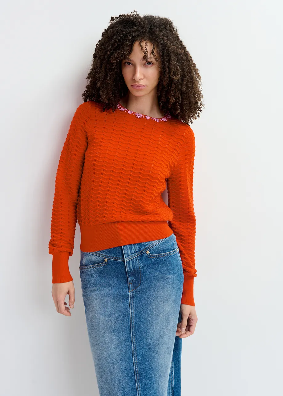 Red knit sweater with embellished neckline