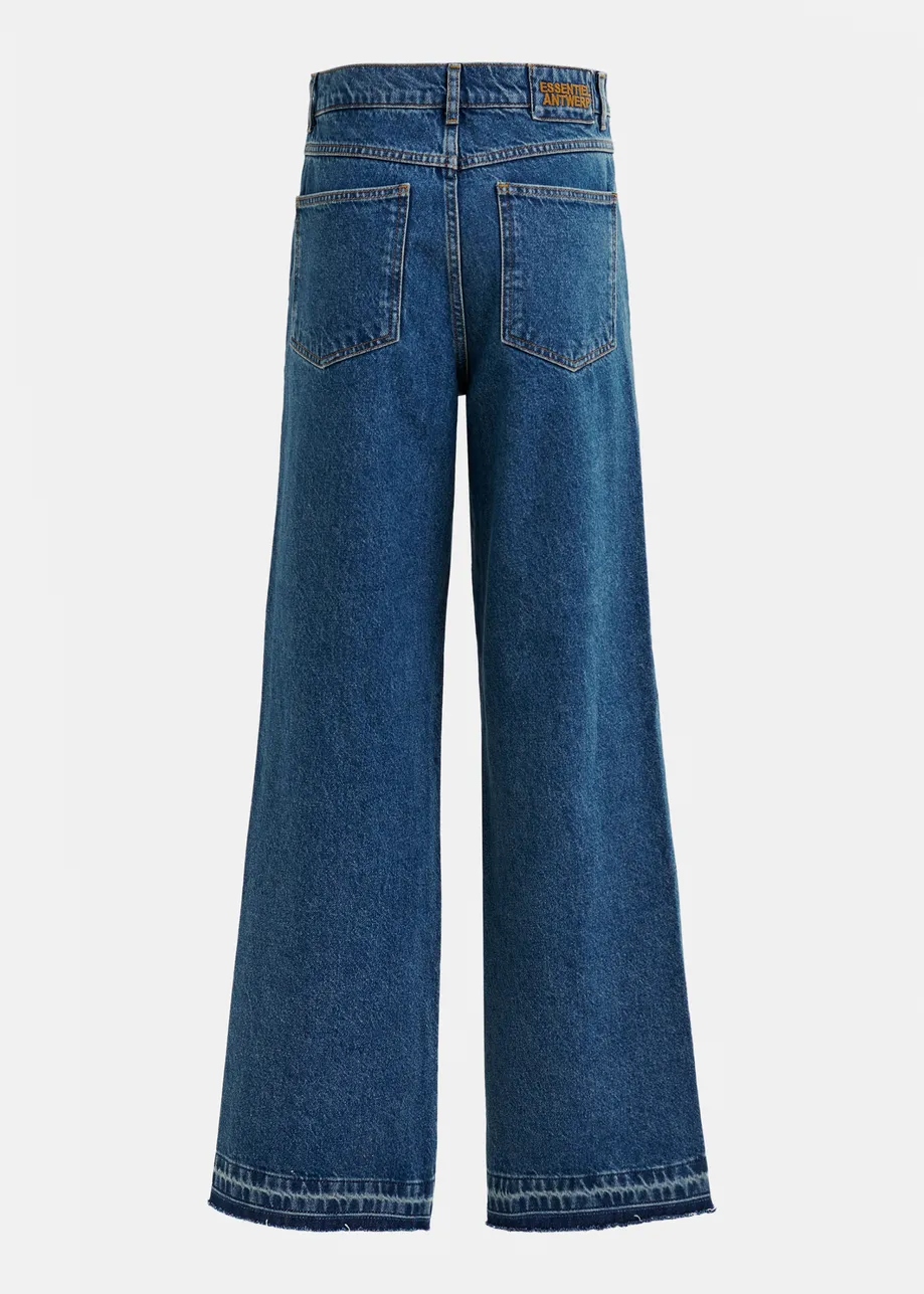 Light and dark blue contrasting panel jeans with uneven waistline and raw-cut hemline.