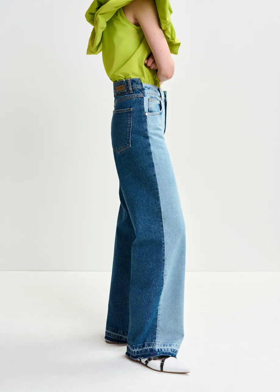 Light and dark blue contrasting panel jeans with uneven waistline and raw-cut hemline.