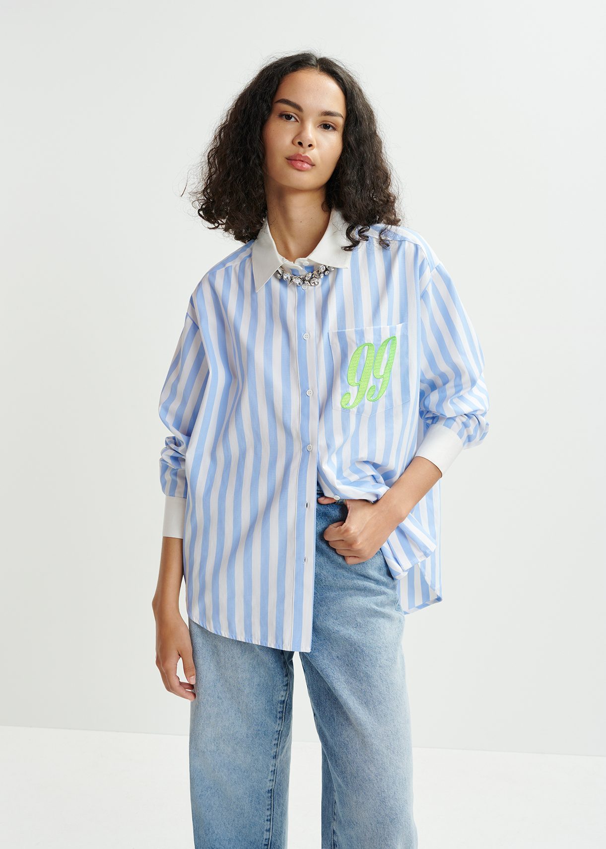 Blue, white and green striped shirt with '99' embroidery