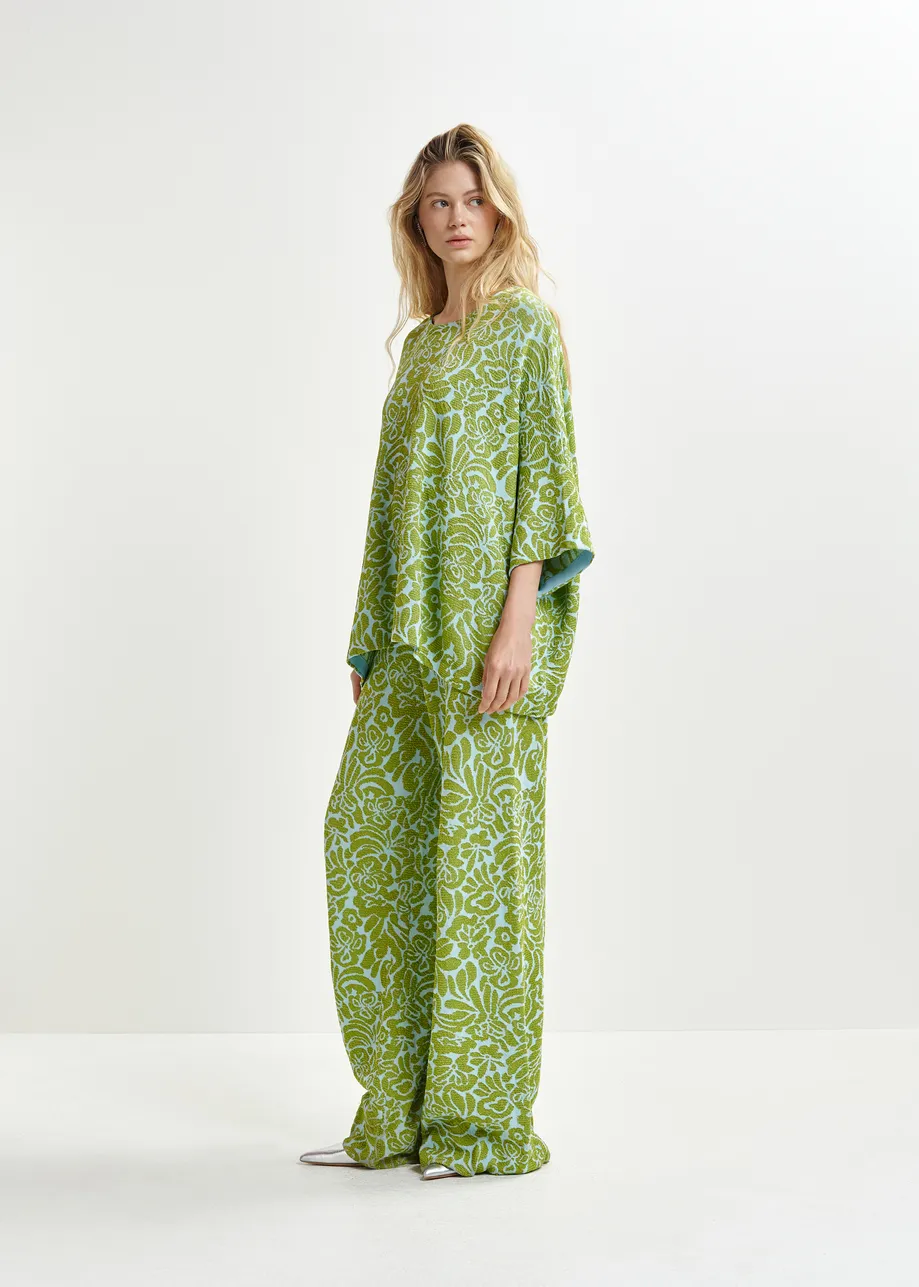 Groene en blauwe broek met olifantenpijpen in bloemenjacquard