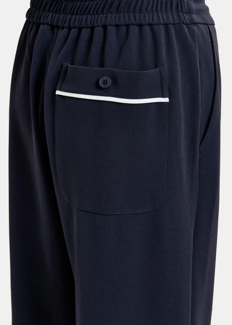 Dark blue and white wide-leg pants with contrasting trim