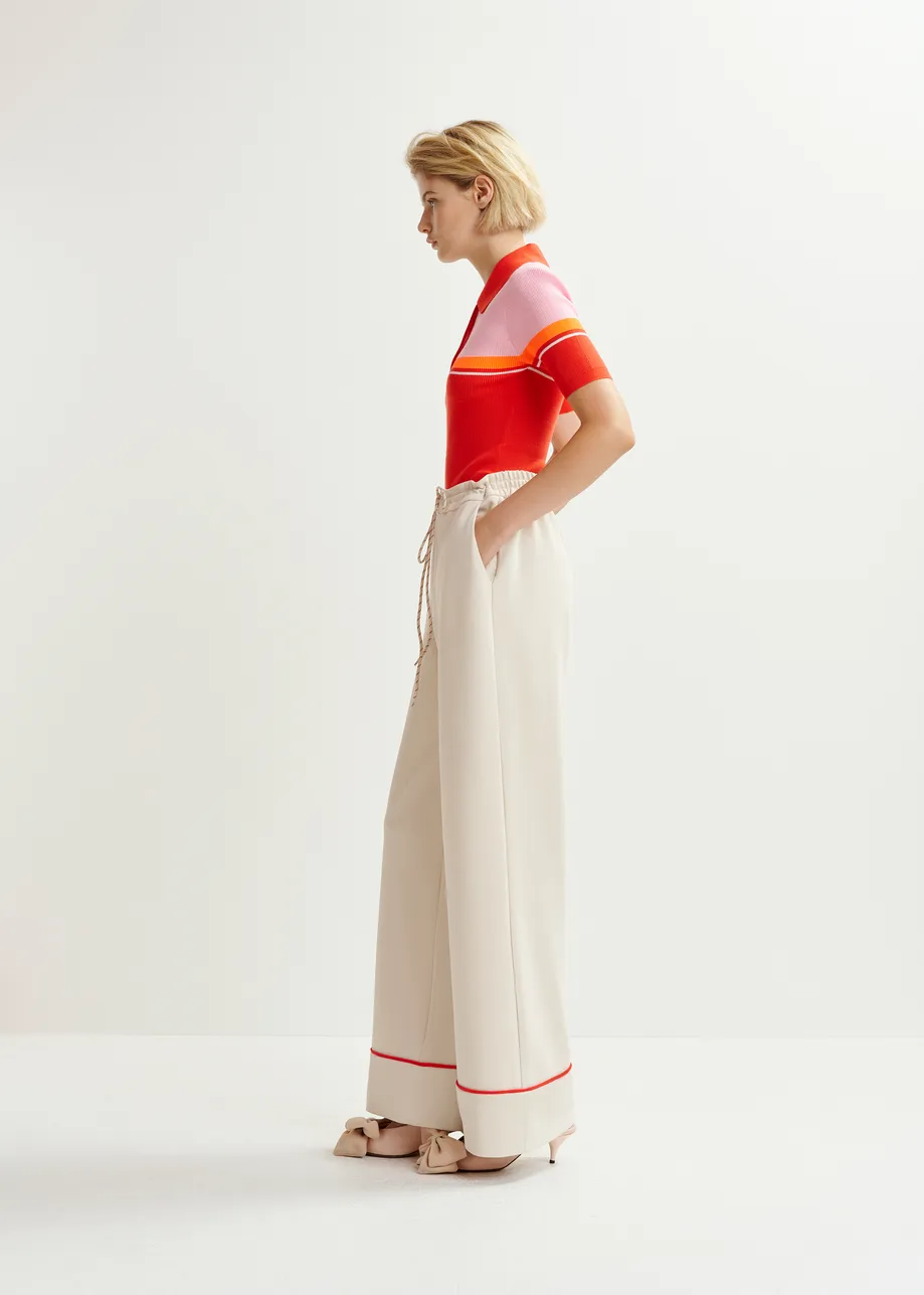 Off-white and red wide-leg pants with contrasting trim