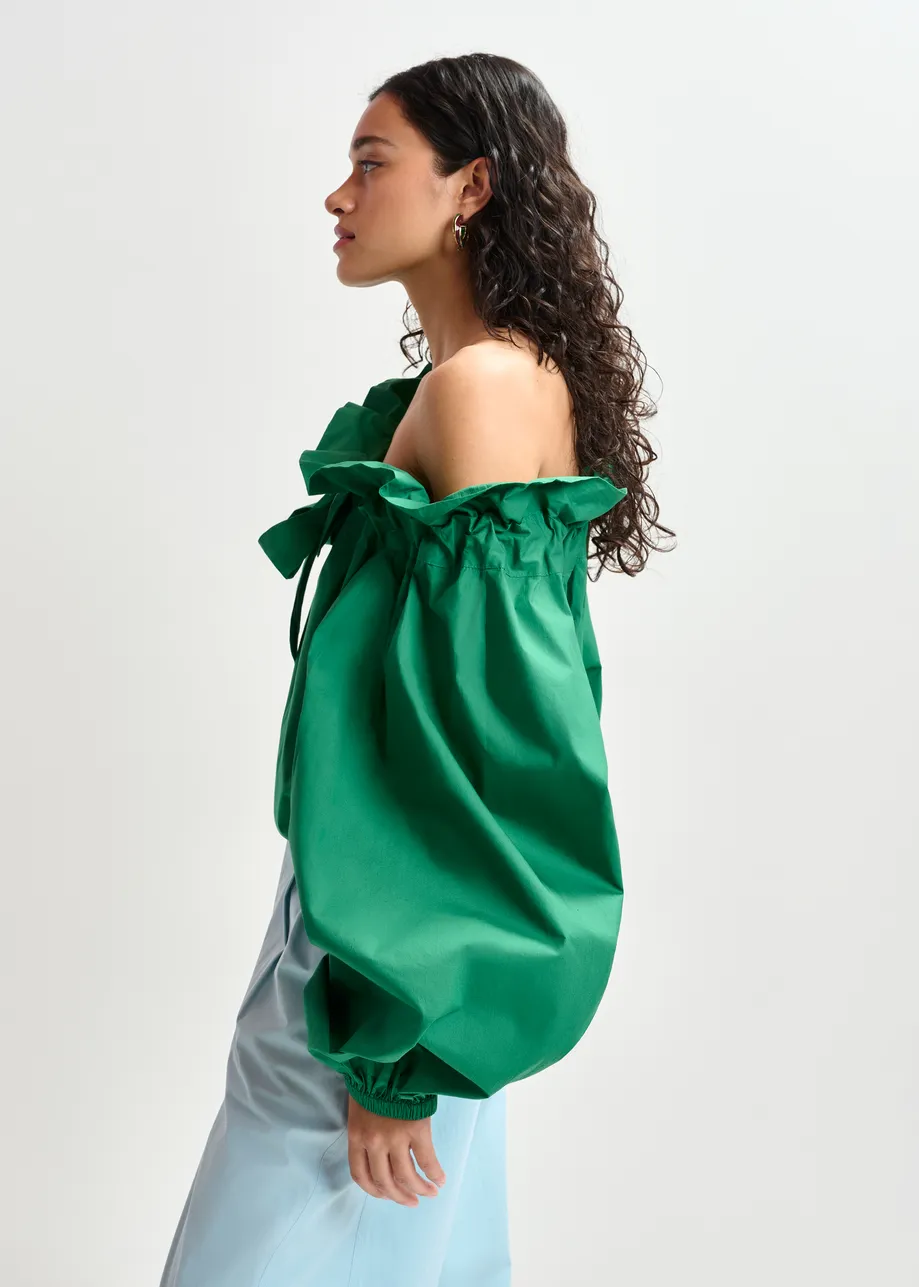 Green cotton top with ruffle details, voluminous sleeves, and self-tie collar