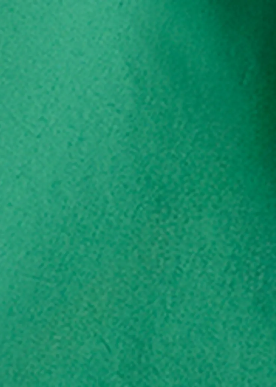 Green cotton top with ruffle details, voluminous sleeves, and self-tie collar