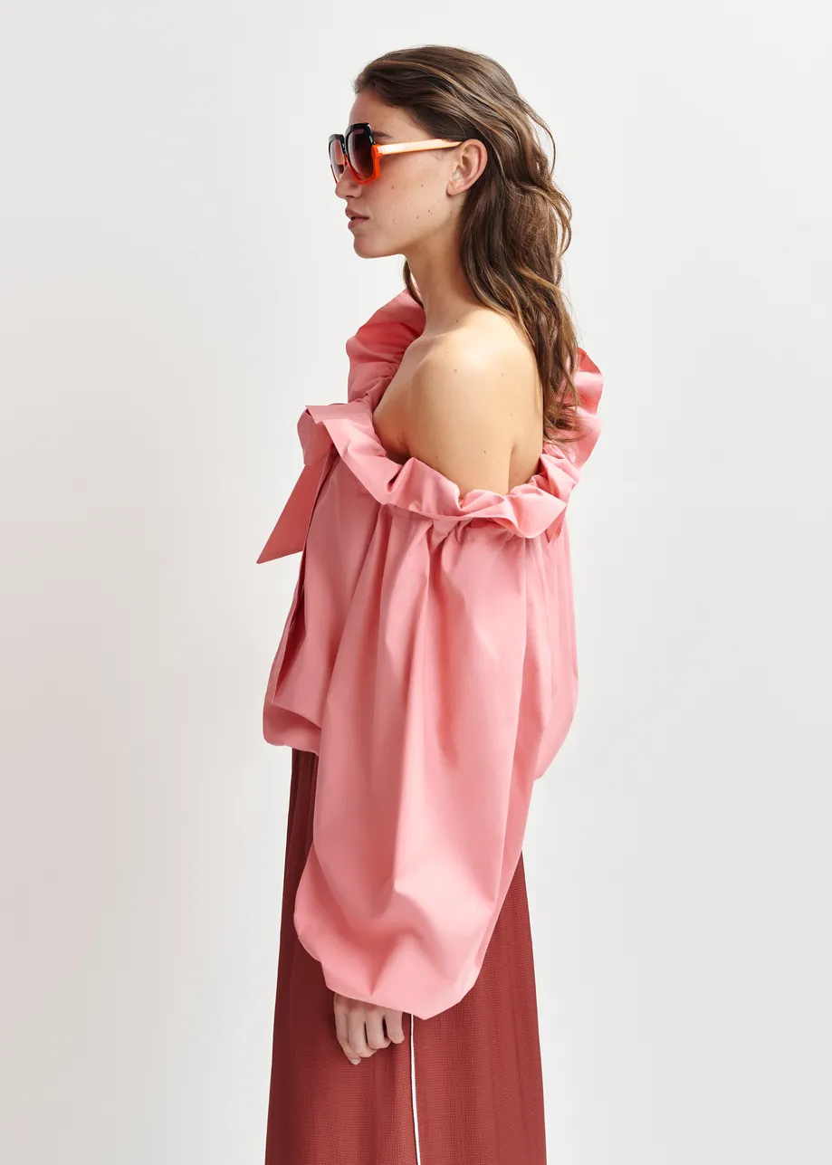 Pink cotton top with ruffle details, voluminous sleeves, and self-tie collar