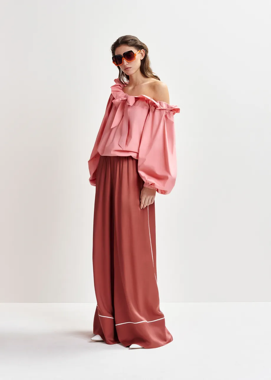 Pink cotton top with ruffle details, voluminous sleeves, and self-tie collar