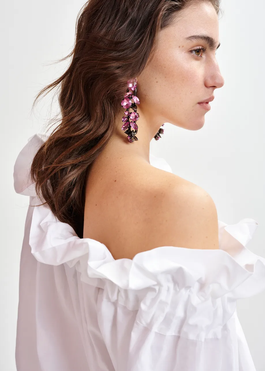 White cotton top with ruffle details, voluminous sleeves, and self-tie collar