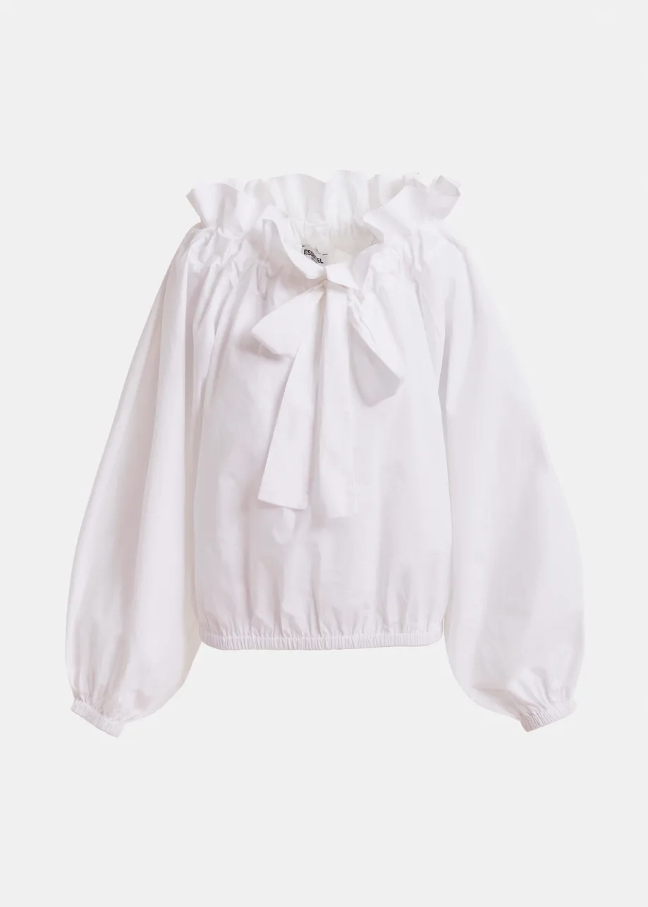 Top in cotone bianco con dettagli a volant, maniche voluminose e colletto con laccetti coordinati.