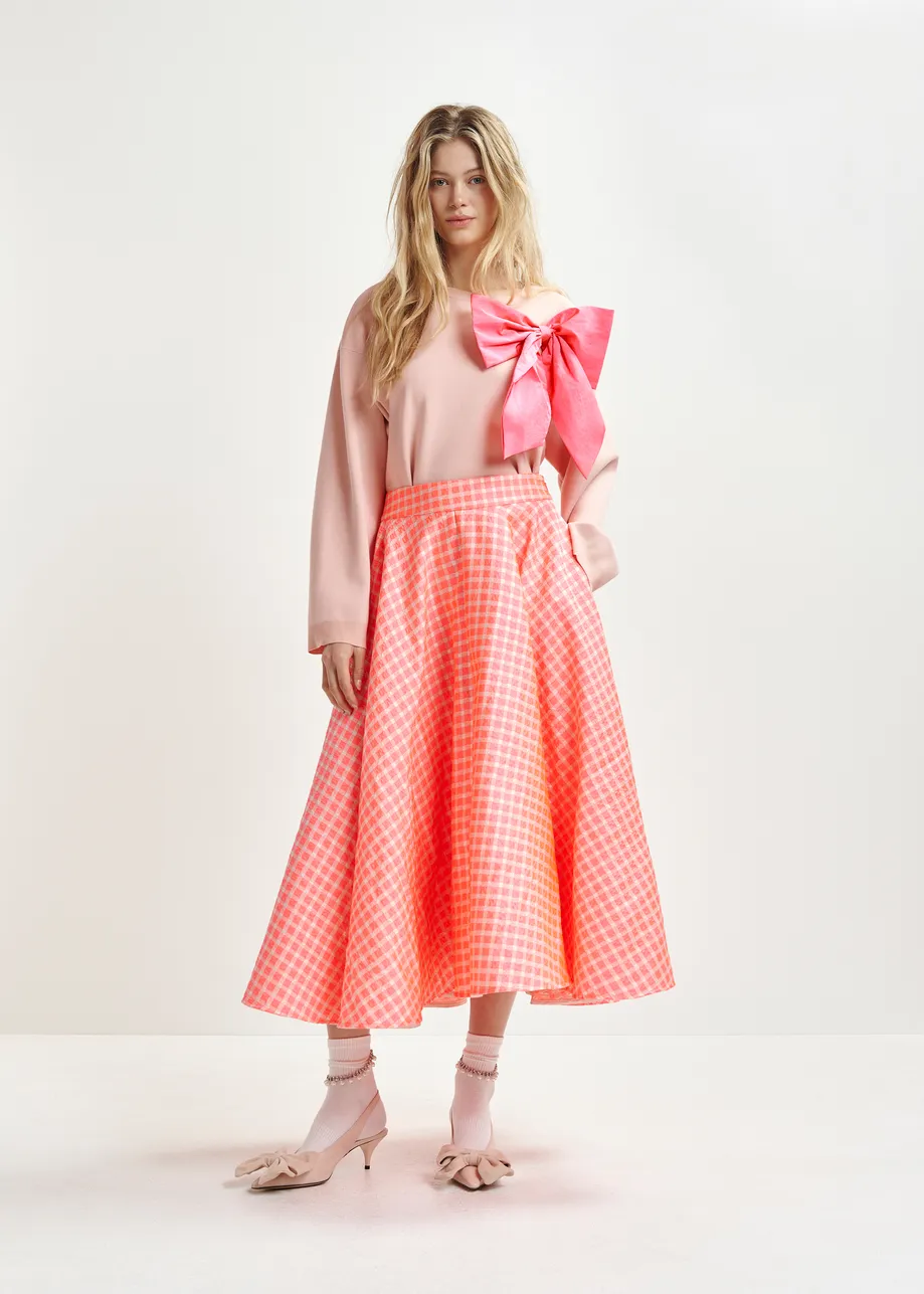 Orange and light pink pleated midi skirt with check pattern