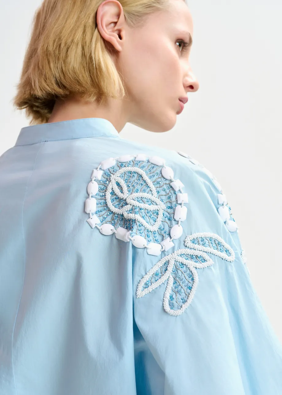 Light blue and white cotton shirt  with bead embellishments and puffed sleeves 