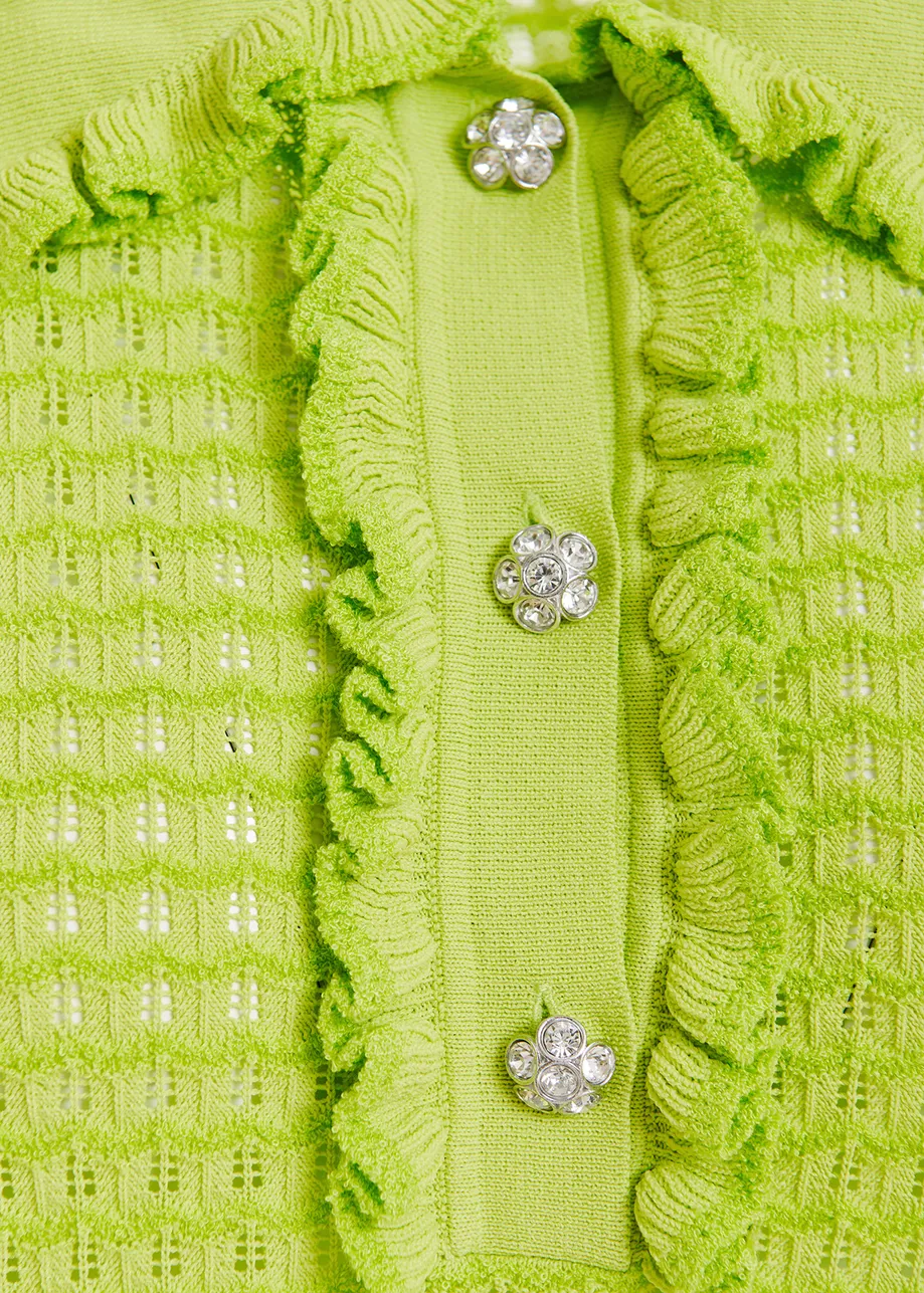 Lime green polo with ruffles and rhinestone-embellished buttons