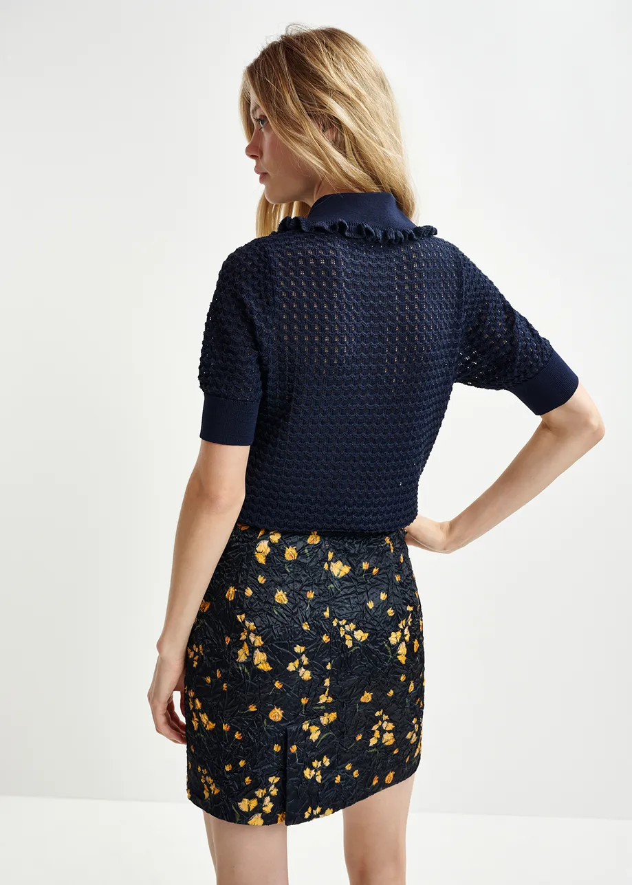 Dark blue polo with ruffles and rhinestone-embellished buttons