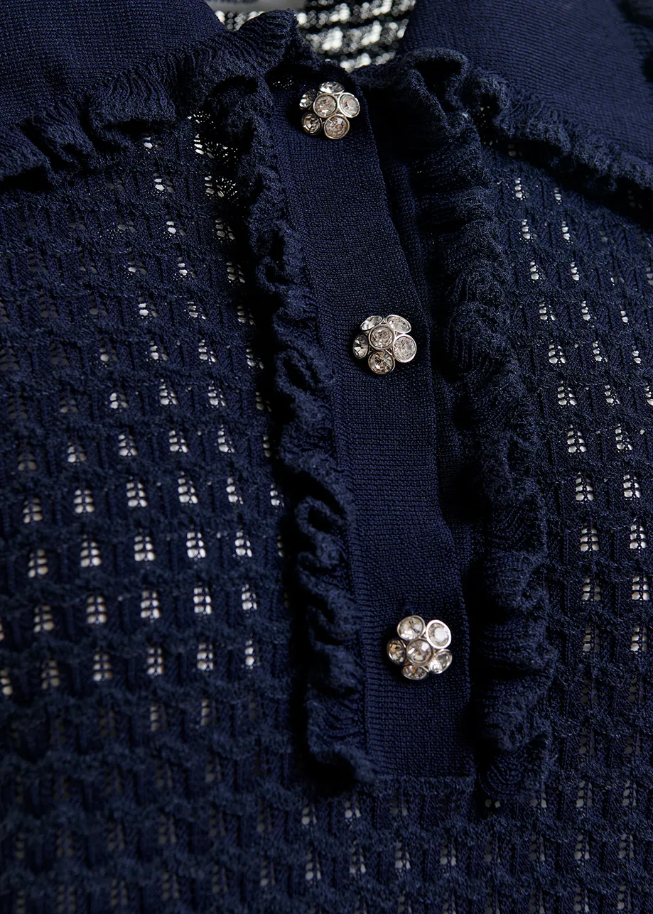 Dark blue polo with ruffles and rhinestone-embellished buttons