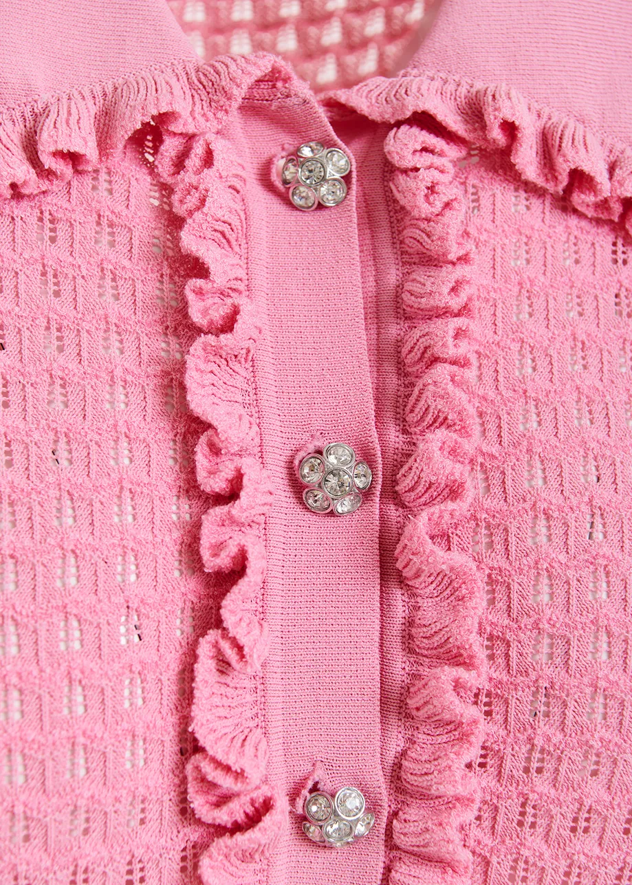 Light pink polo with ruffles and rhinestone-embellished buttons