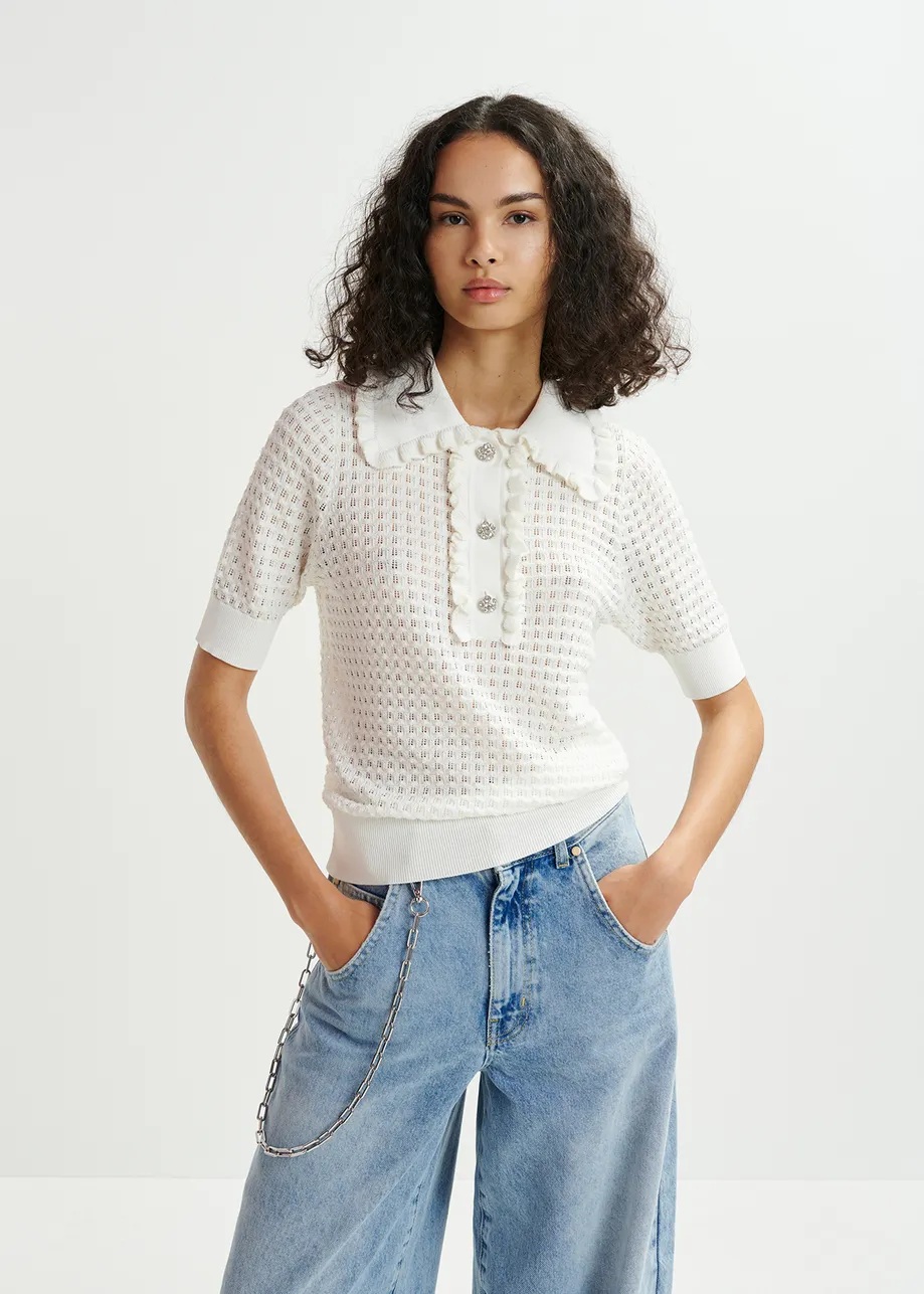 Off-white polo with ruffles and rhinestone-embellished buttons