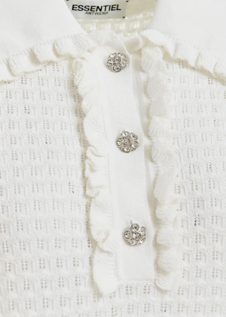 Off-white polo with ruffles and rhinestone-embellished buttons