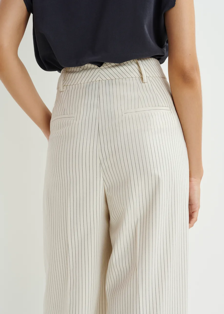 Dark blue and white pinstriped tapered leg pants