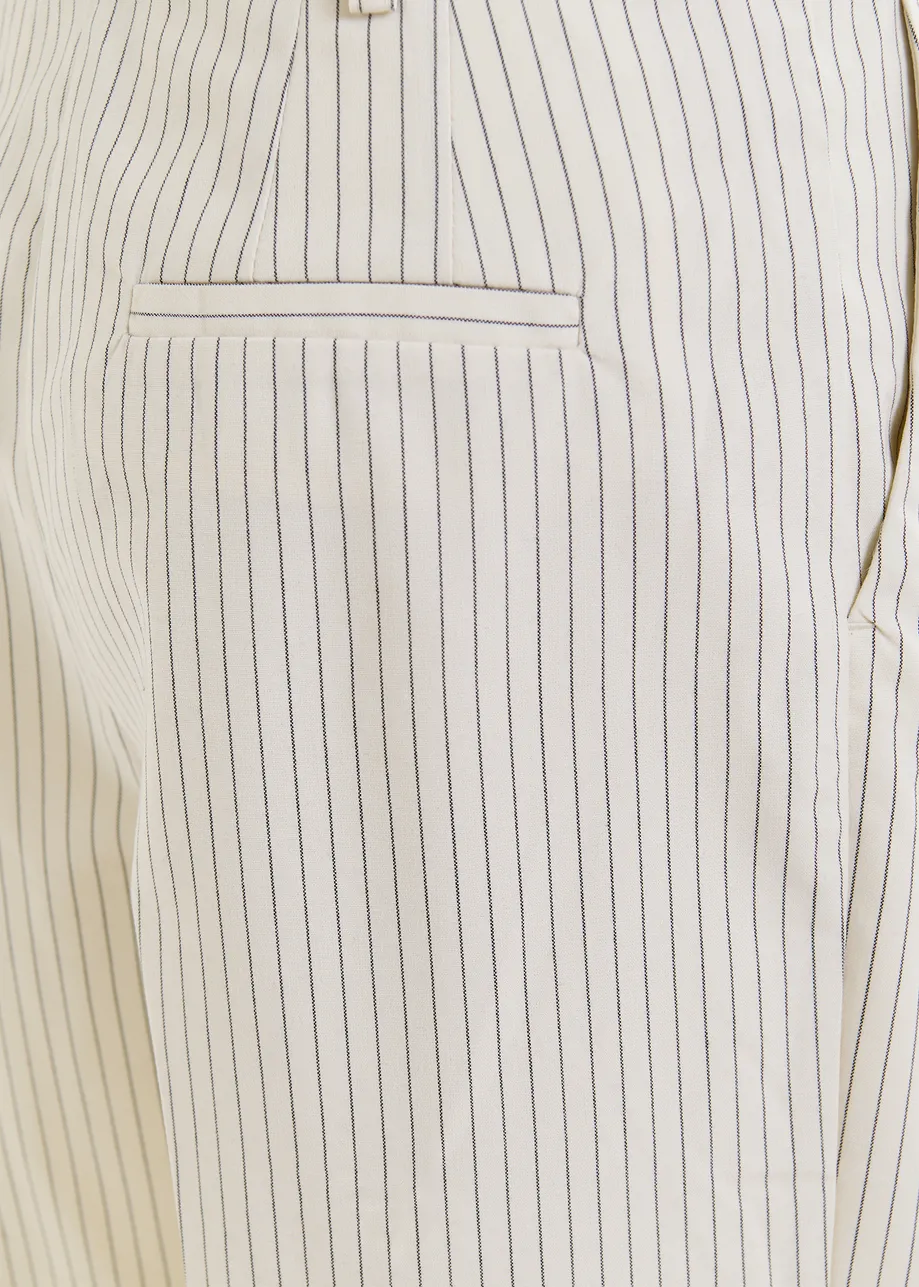 Dark blue and white pinstriped tapered leg pants