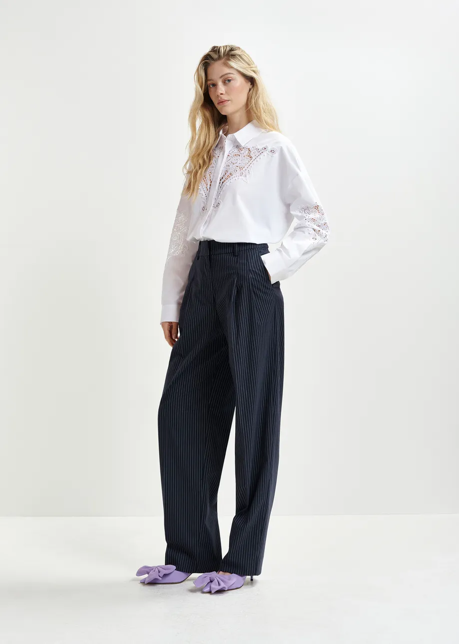 Dark blue and white pinstriped tapered leg pants