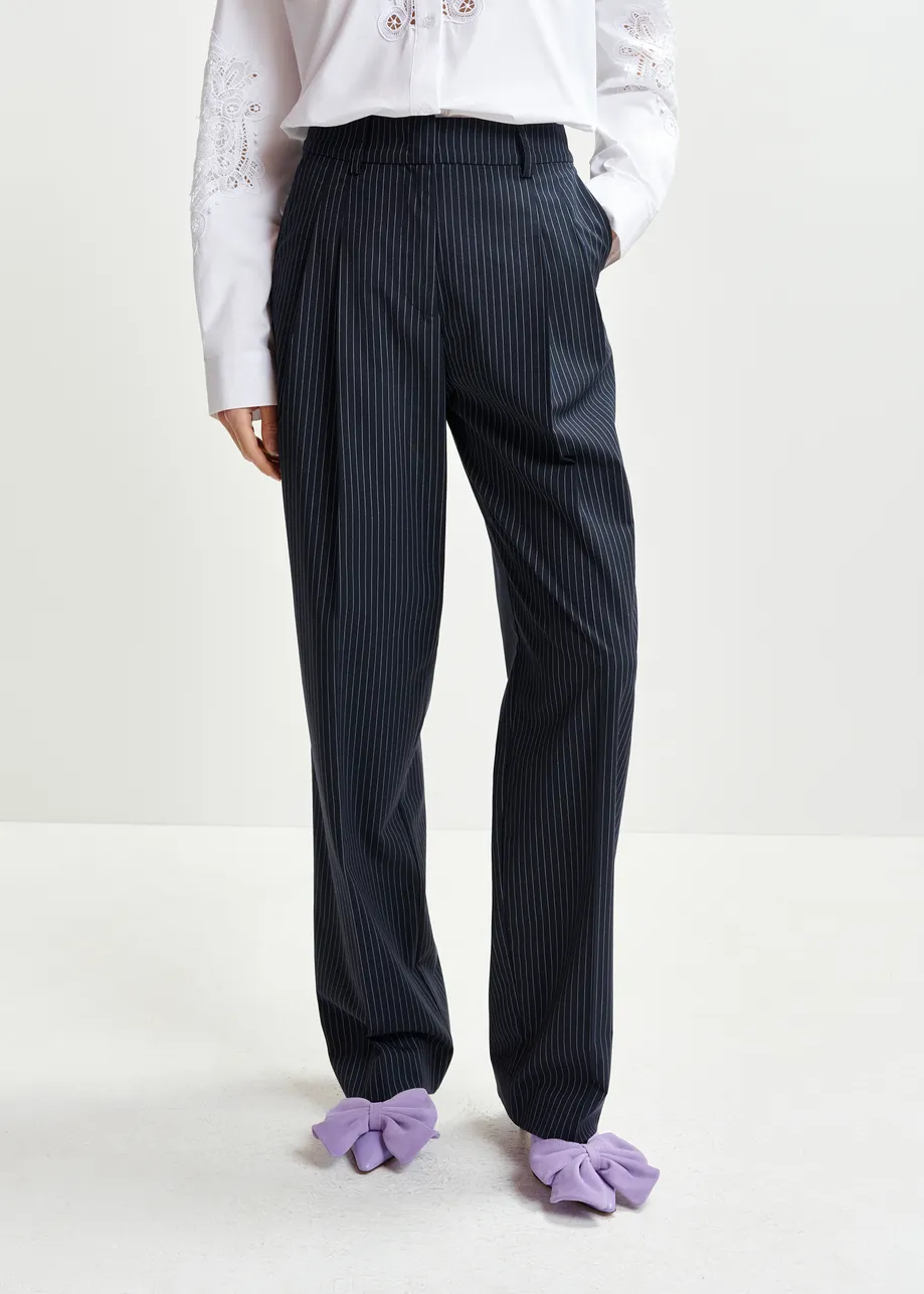 Dark blue and white pinstriped tapered leg pants