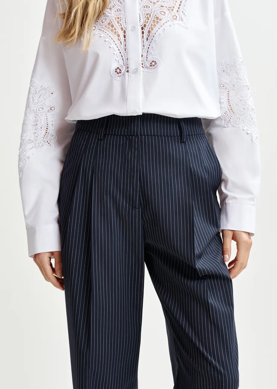Dark blue and white pinstriped tapered leg pants