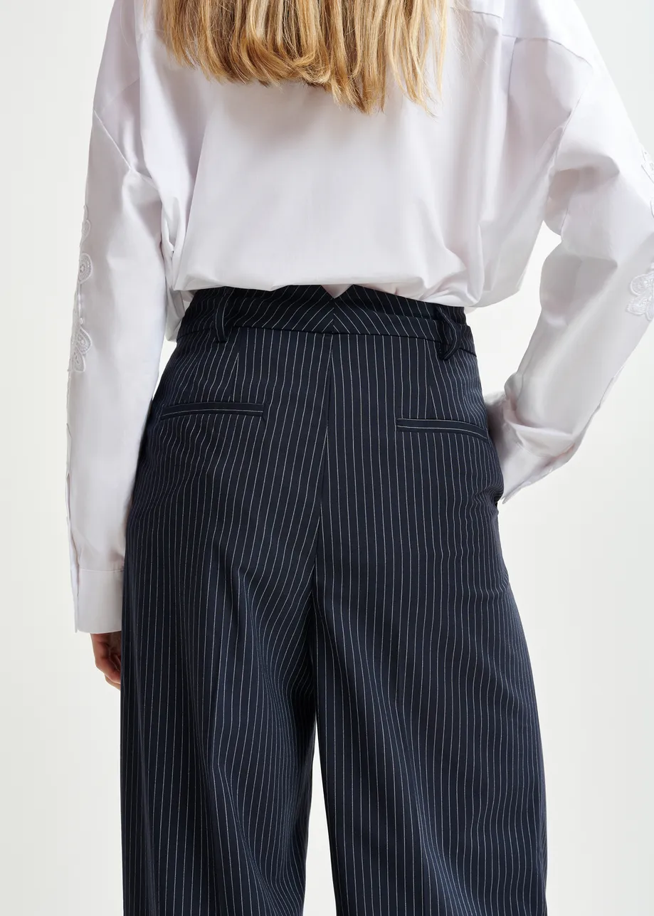 Dark blue and white pinstriped tapered leg pants