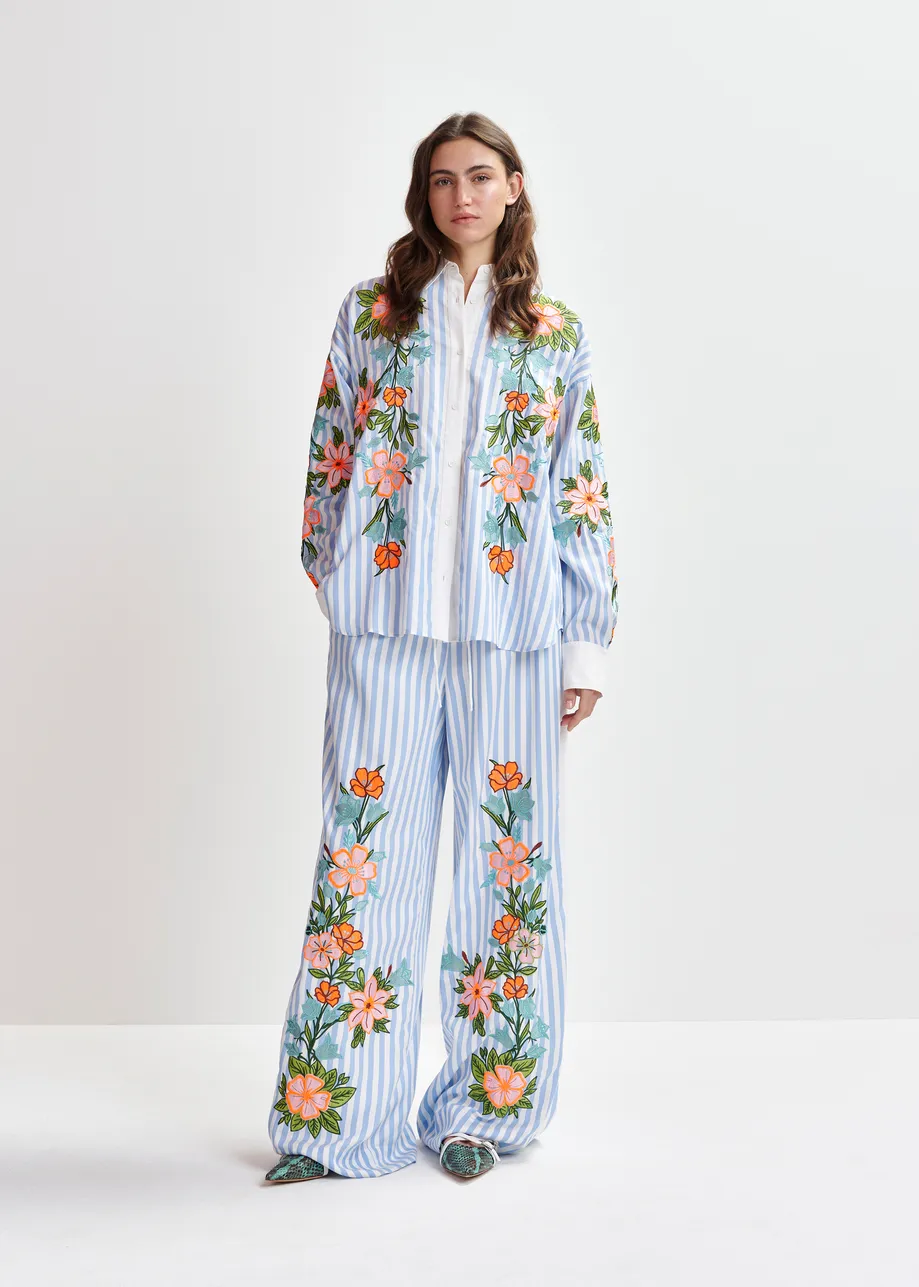 Blue, white and multicolored wide-leg pants with contrast border and embroideries