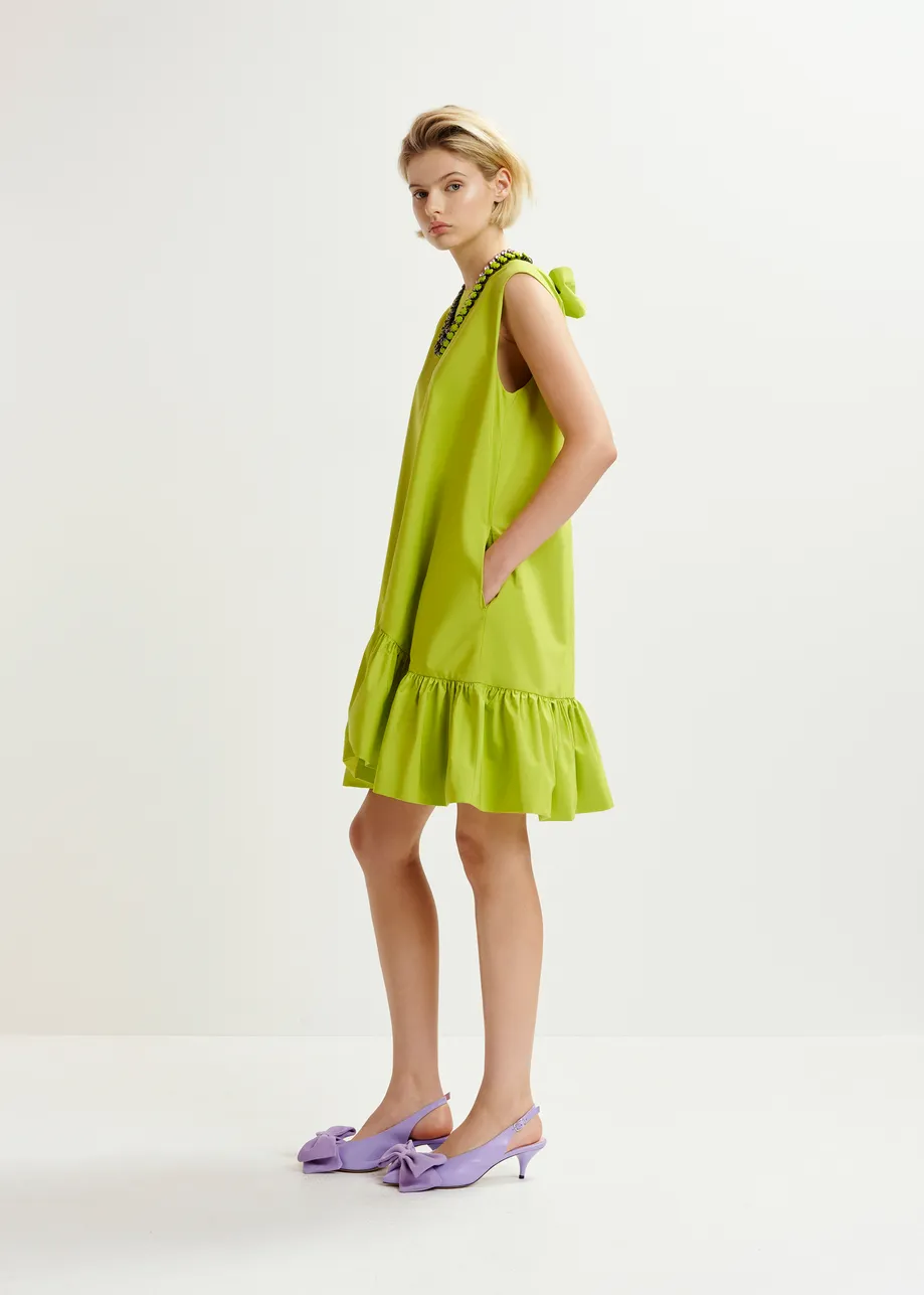 Green ruffled mini dress with open-back and bow detail