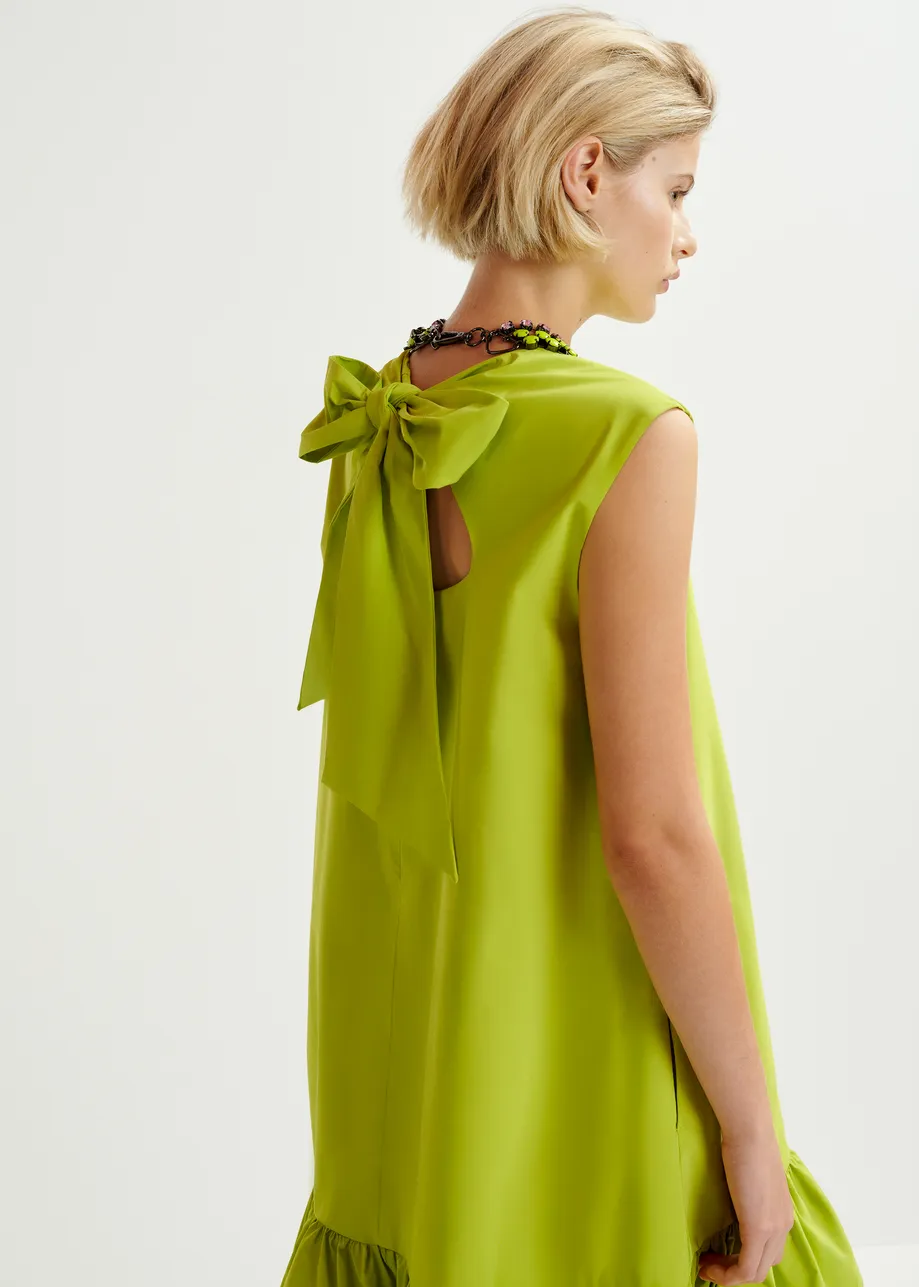 Green ruffled mini dress with open-back and bow detail