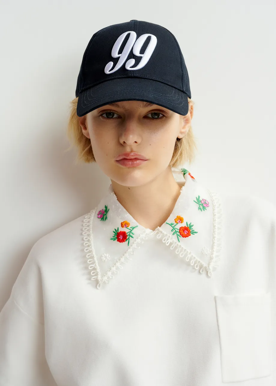 White, green and red knitted top with embroidered lace collar