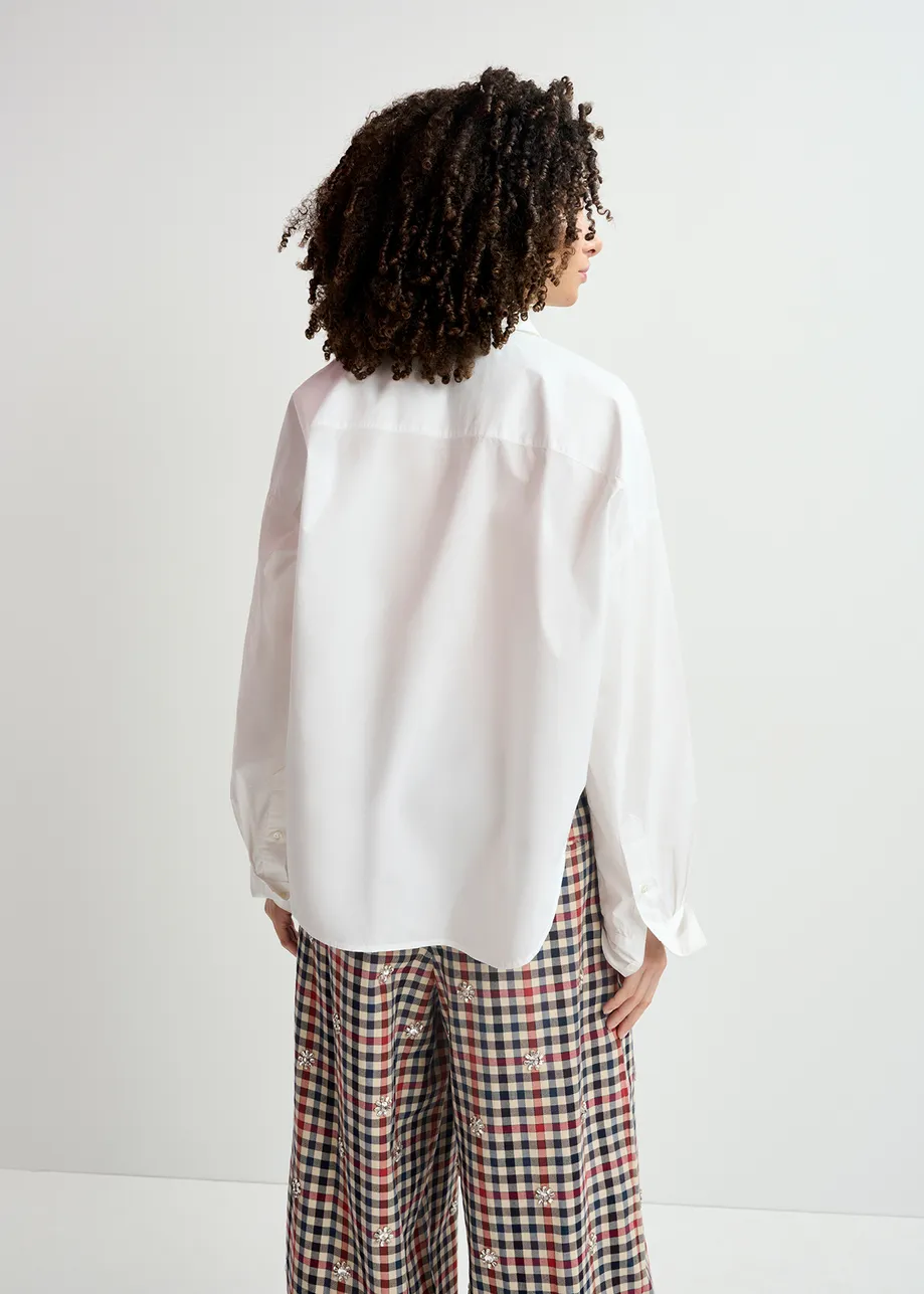 Chemise en coton blanche avec ornements à la patte de boutonnage