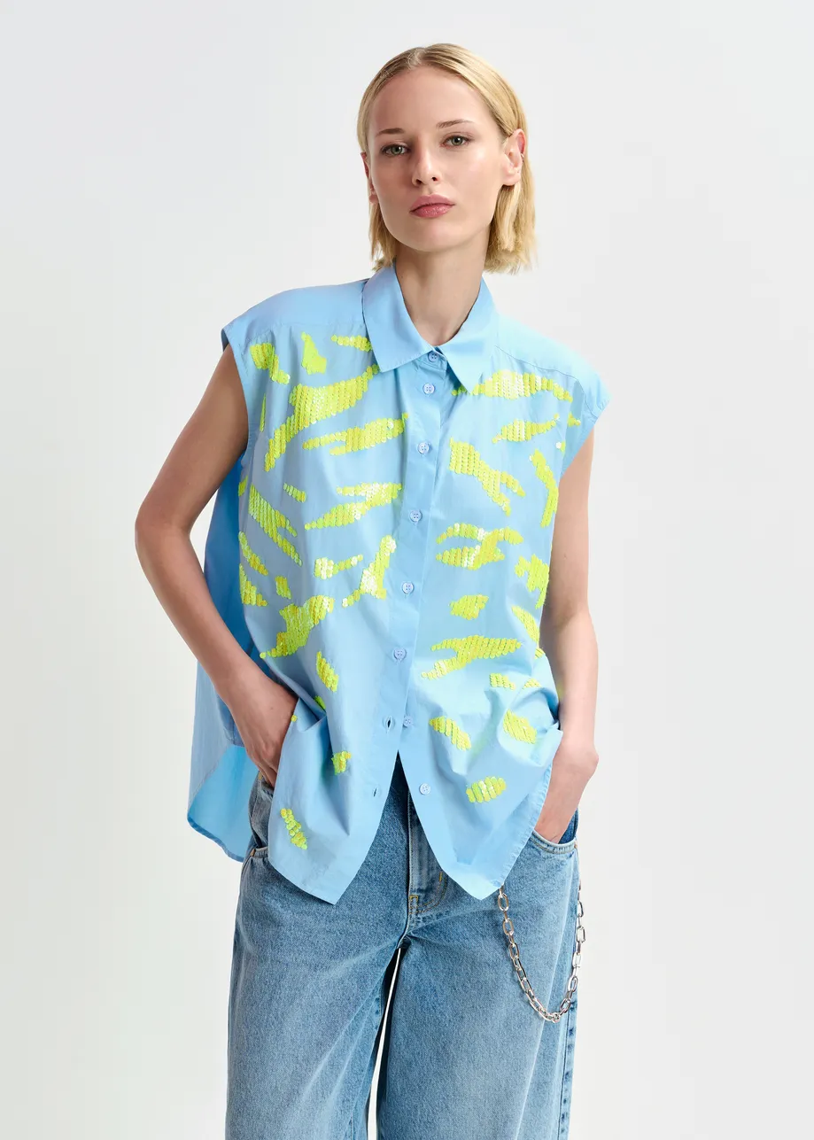 Light blue and yellow sleeveless cotton shirt with embellishments