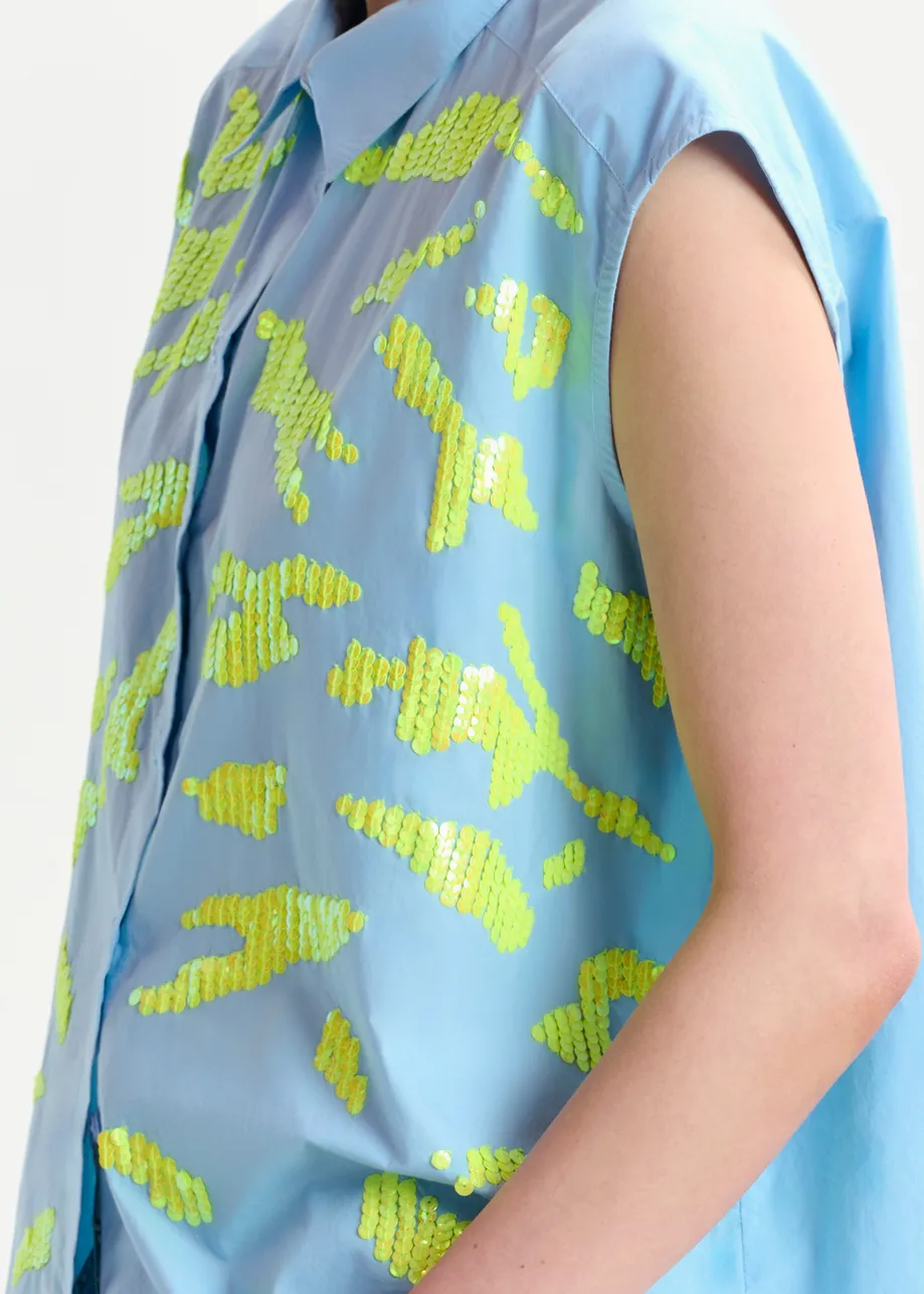 Light blue and yellow sleeveless cotton shirt with embellishments