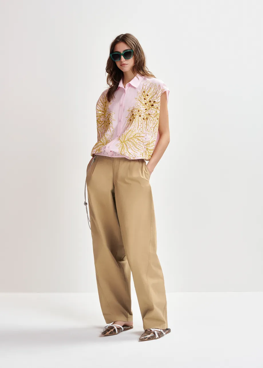 Brown tapered-leg pants with rhinestone belt