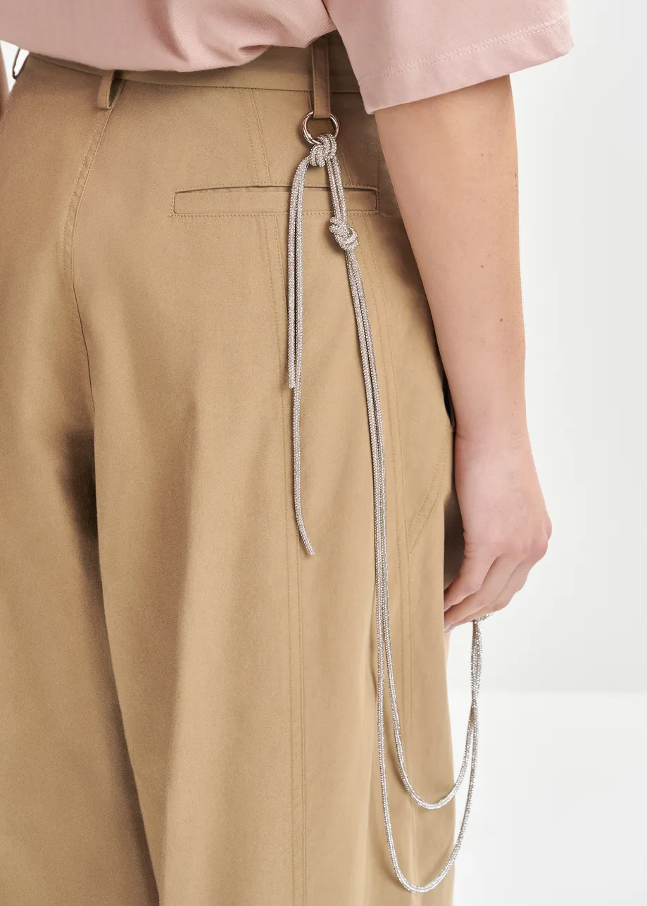 Brown tapered-leg pants with rhinestone belt