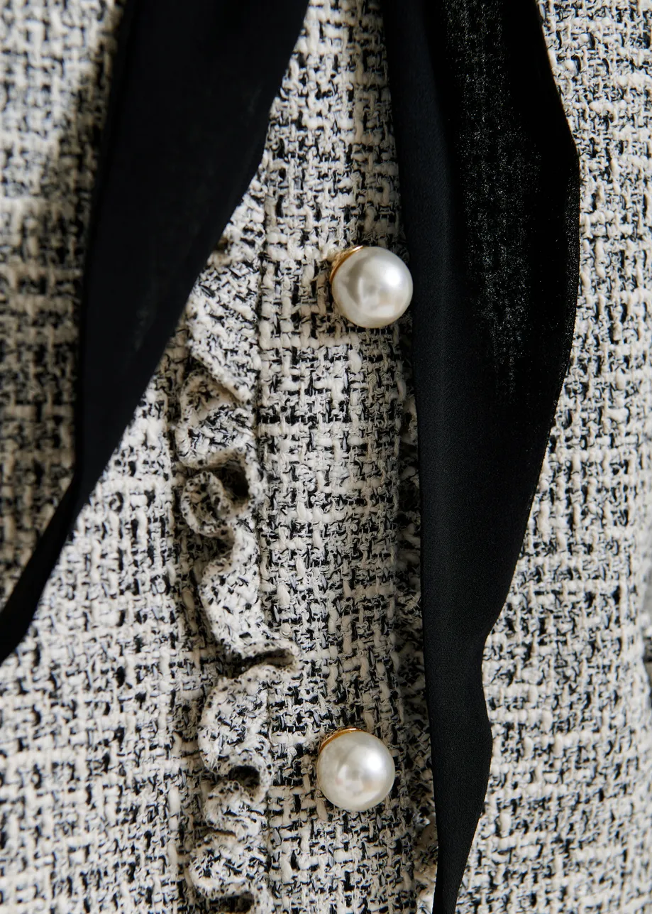 Black and white jacket with pearl buttons and pussy bow