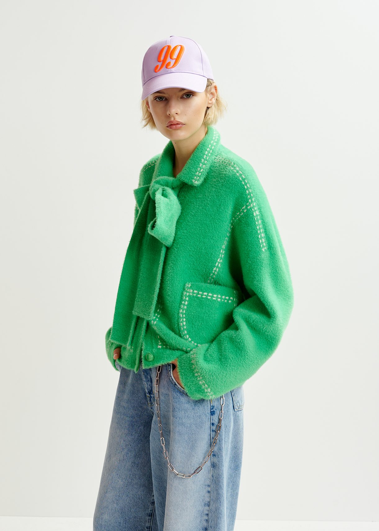 Green knit with contrasting stitching and self-fabric scarf