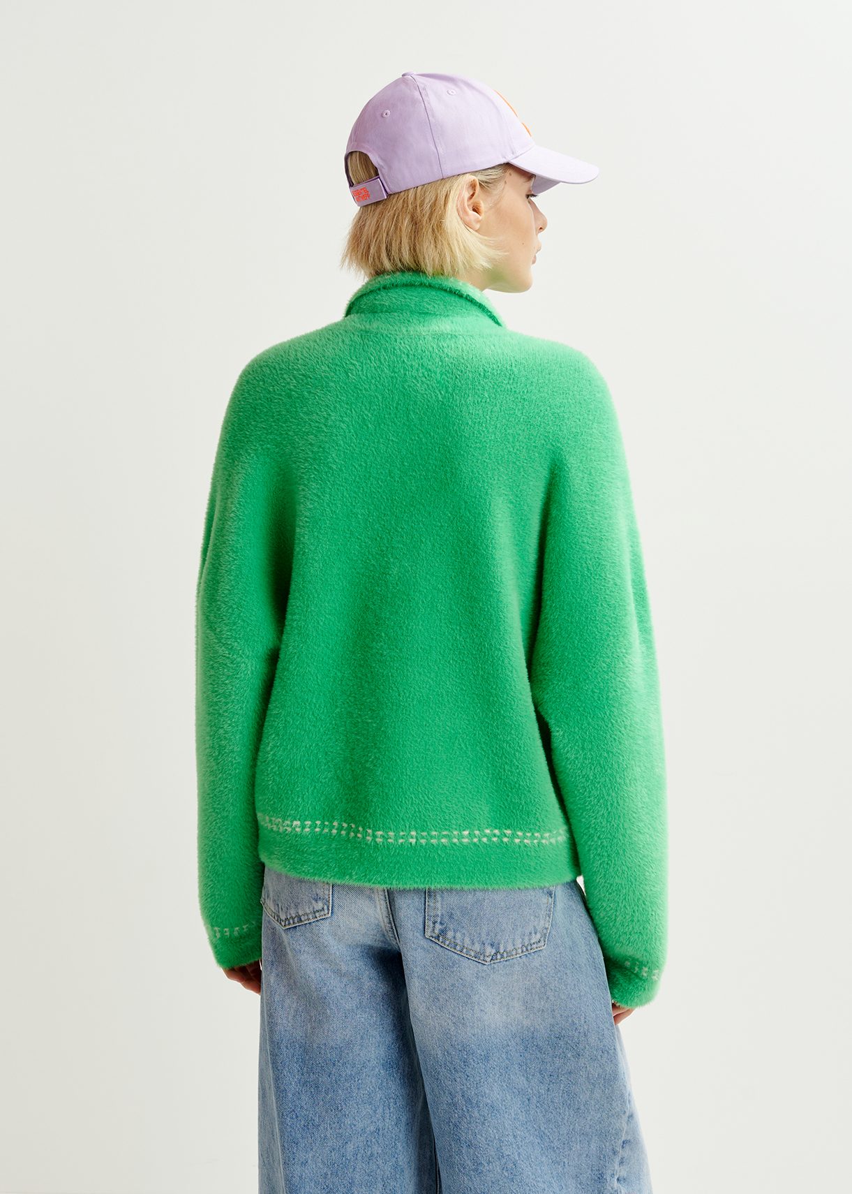 Green knit with contrasting stitching and self-fabric scarf