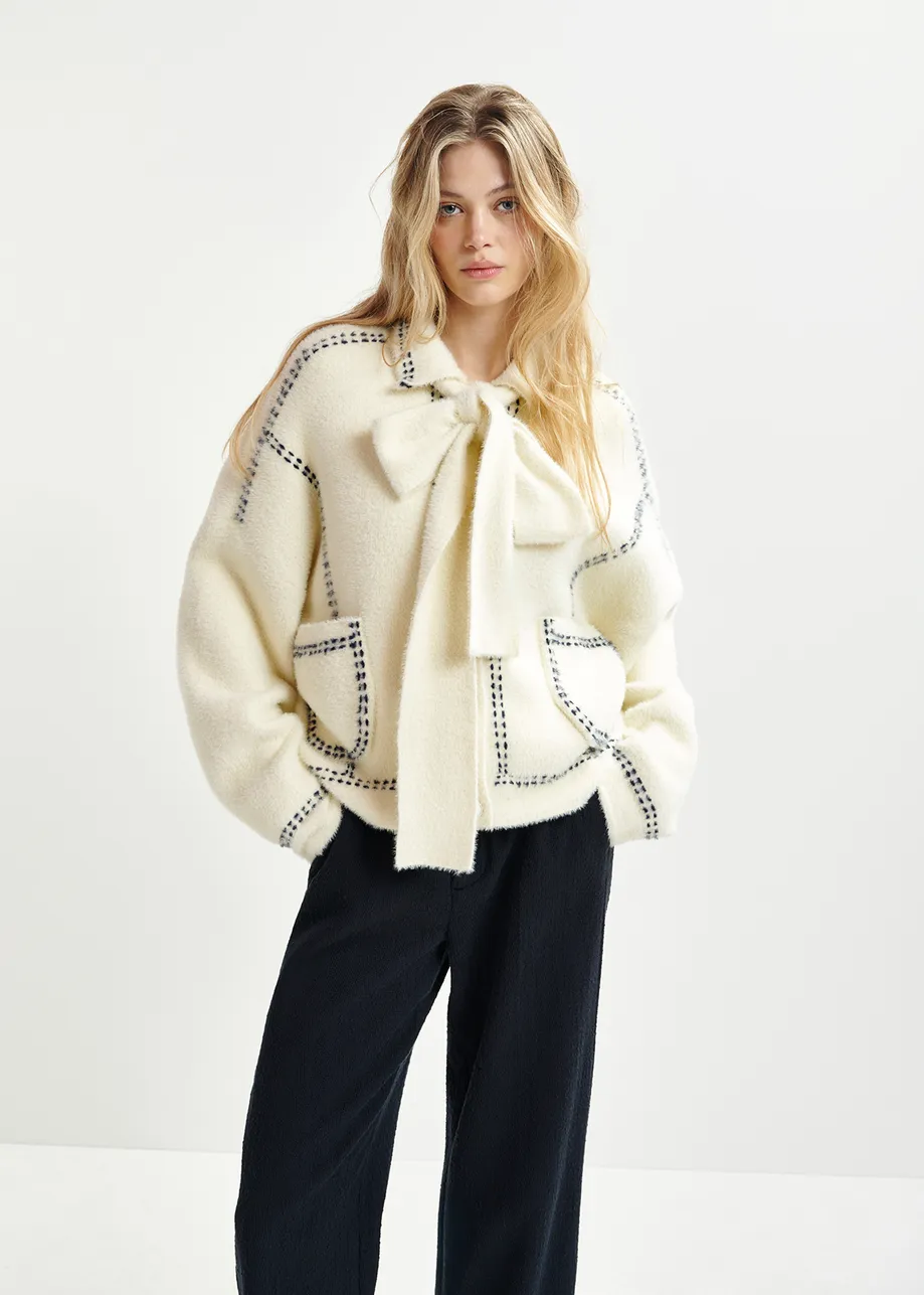 White knit with contrasting stitching and self-fabric scarf