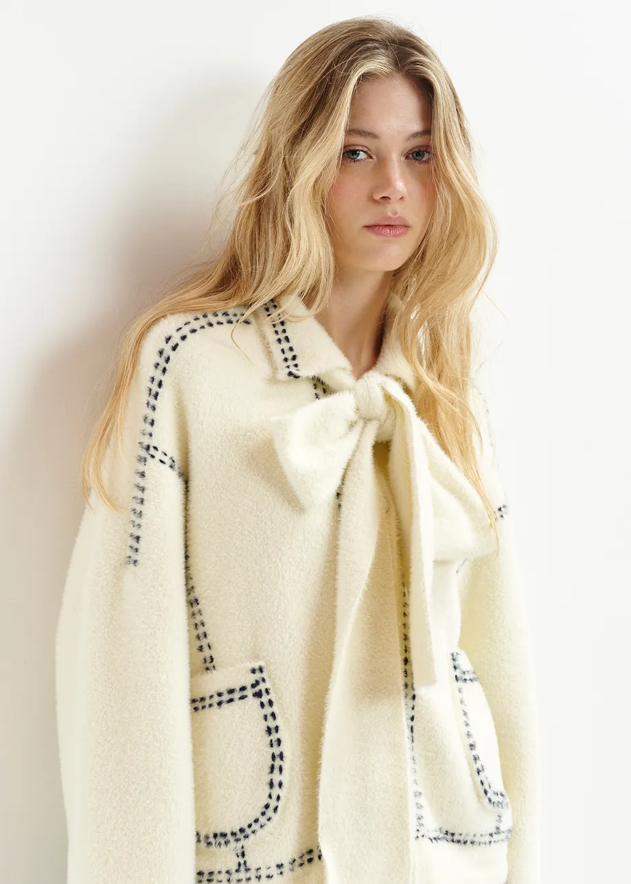 White knit with contrasting stitching and self-fabric scarf