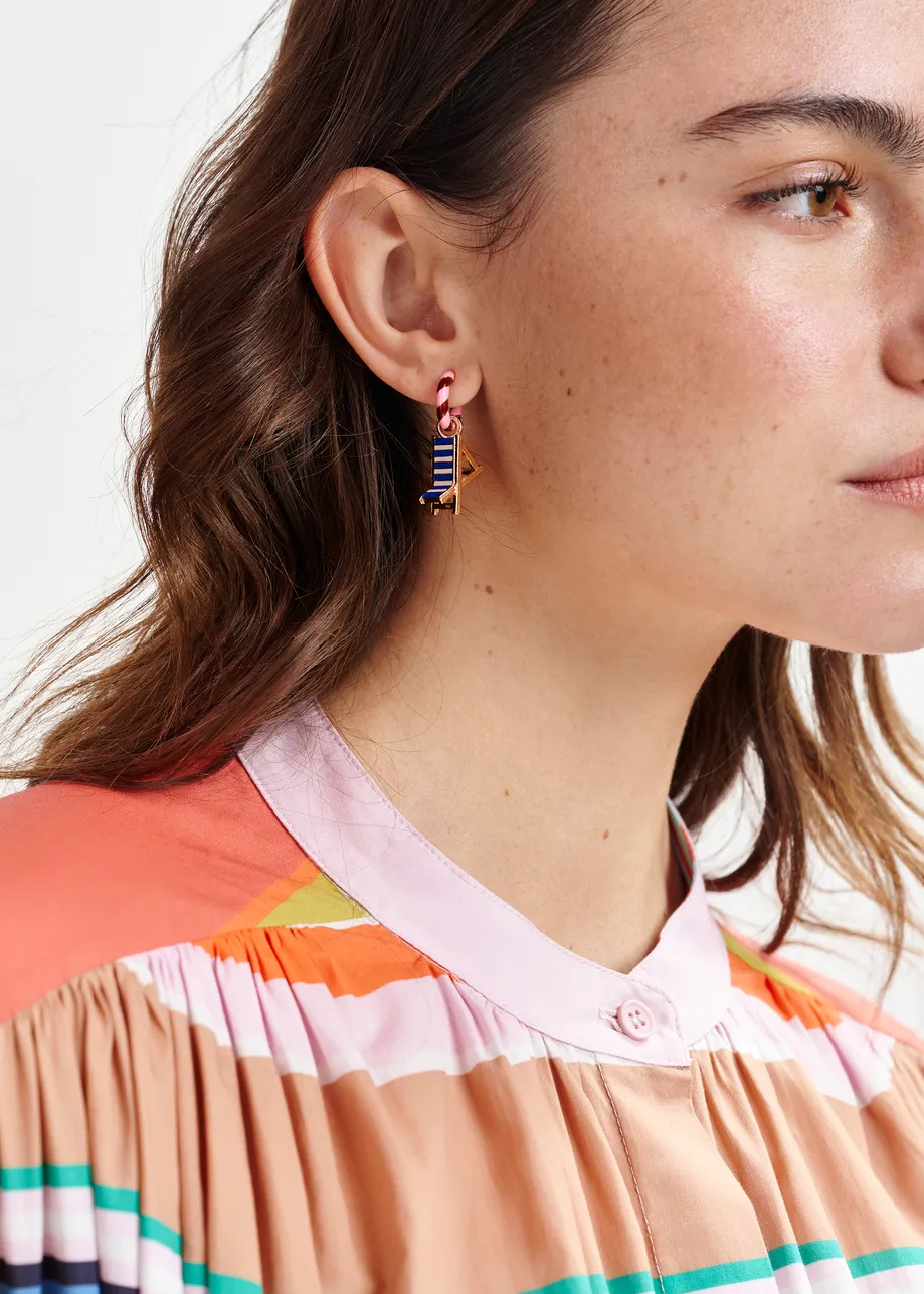 Pink and burgundy hoop earrings with frog and chair pendants