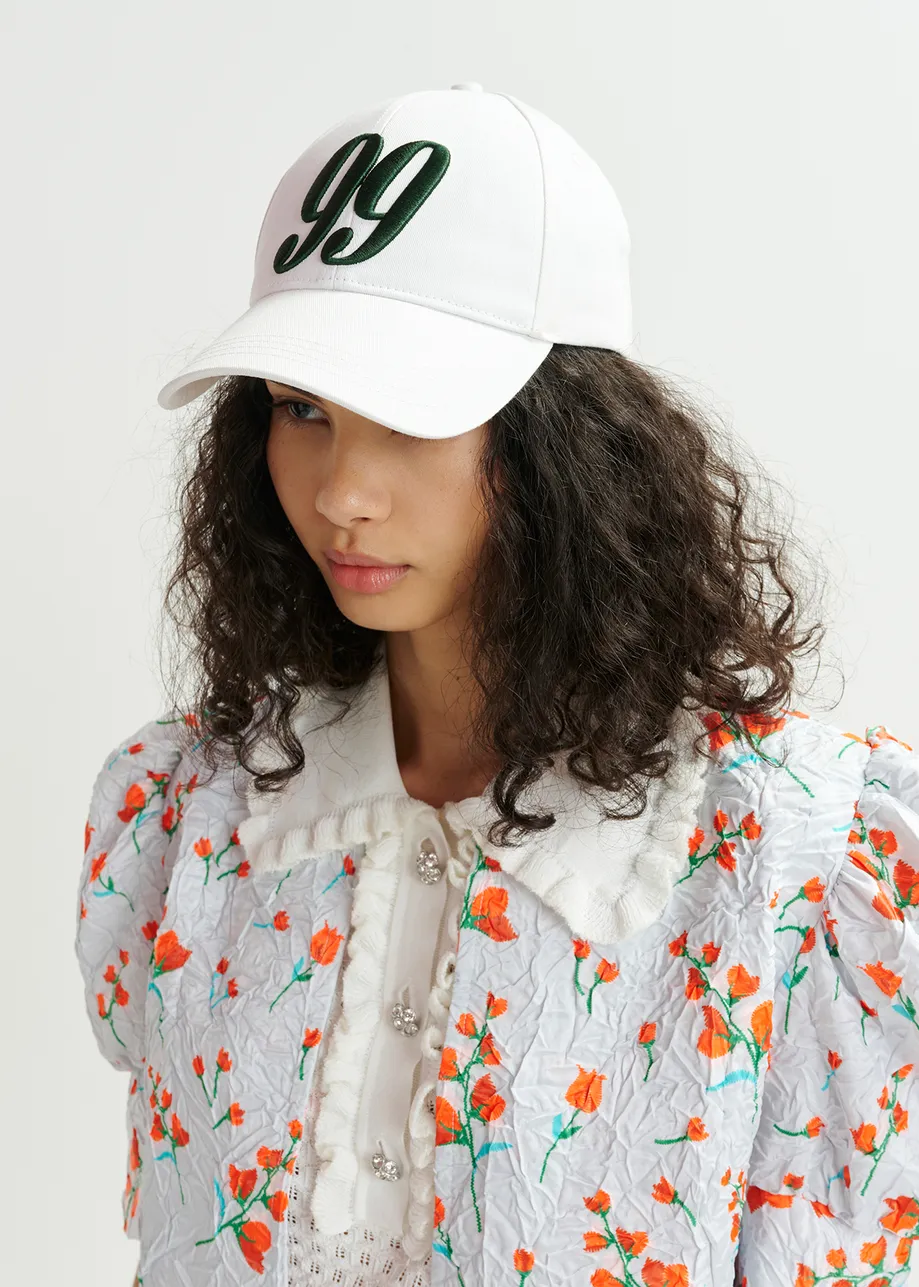 Veste courte blanche à imprimé fleuri et épaules bouffantes