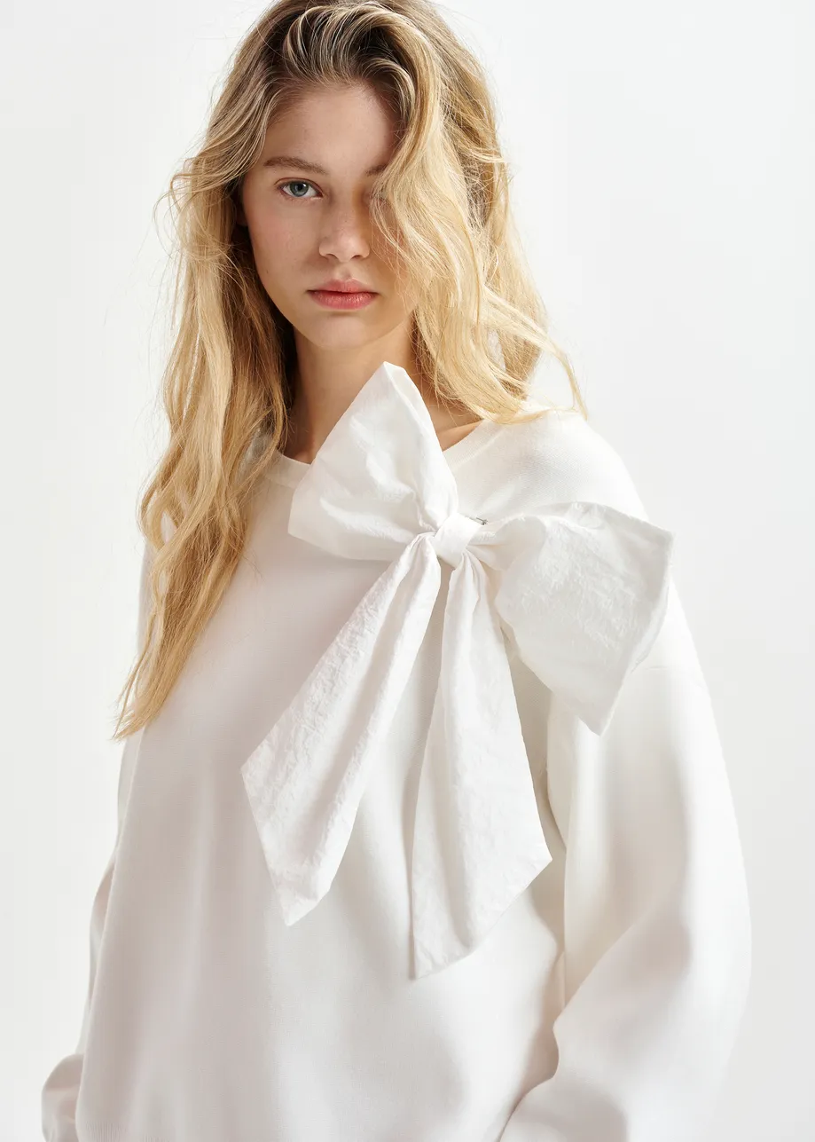 White sweater with removable bow detail