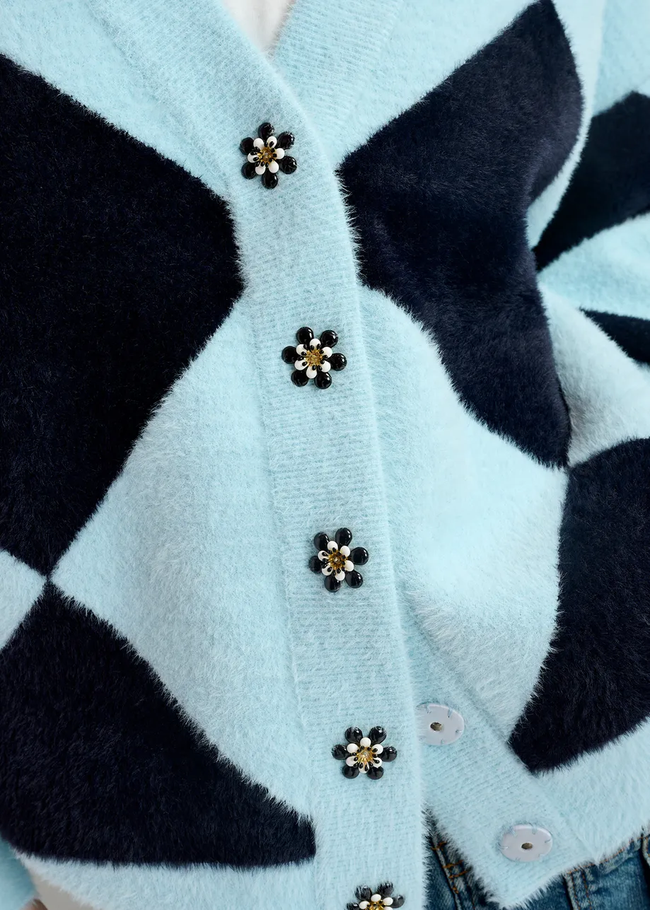 Blue harlequin-patterned knit cardigan with flower-shaped buttons

