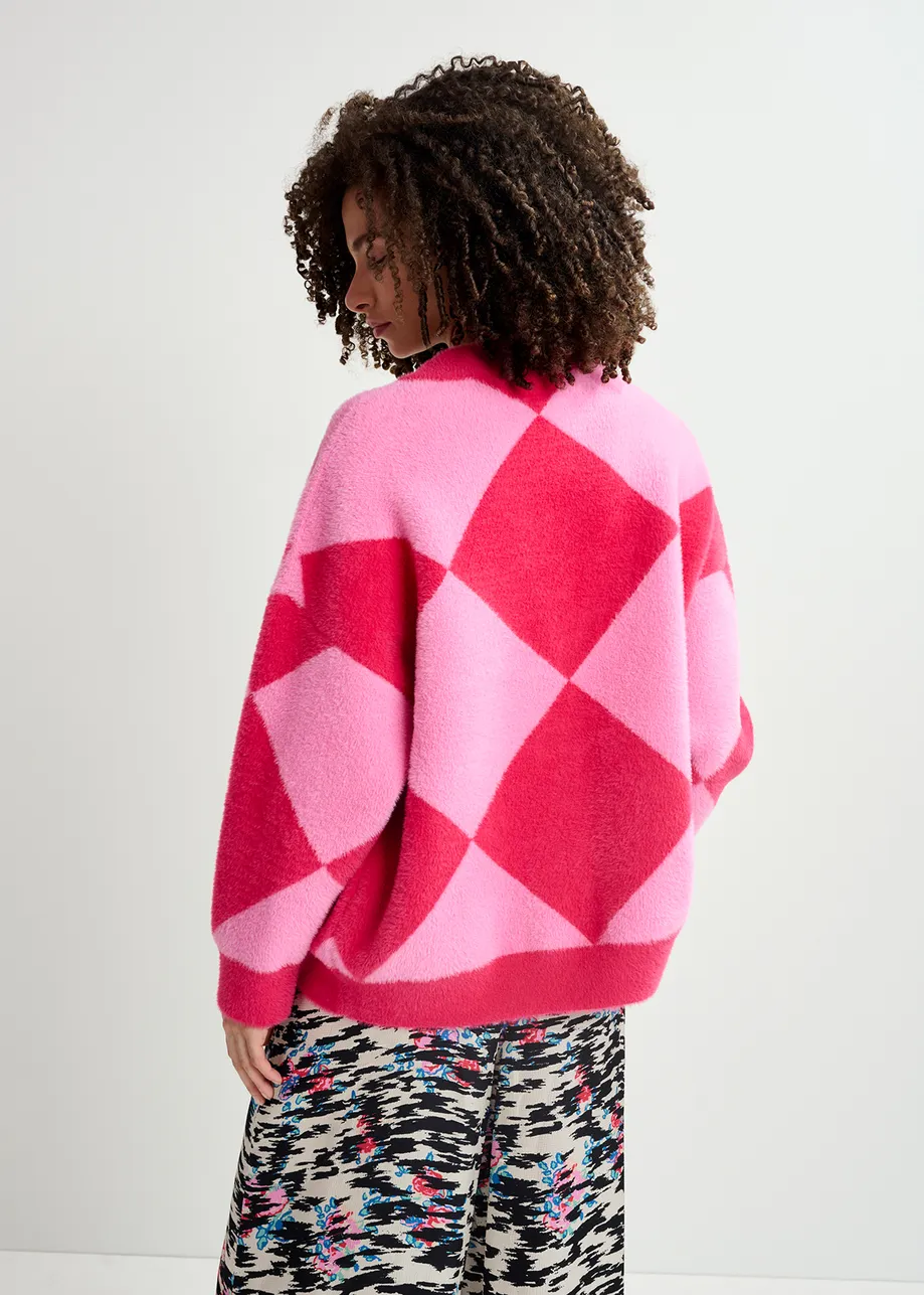 Pink harlequin-patterned knit cardigan with flower-shaped buttons

