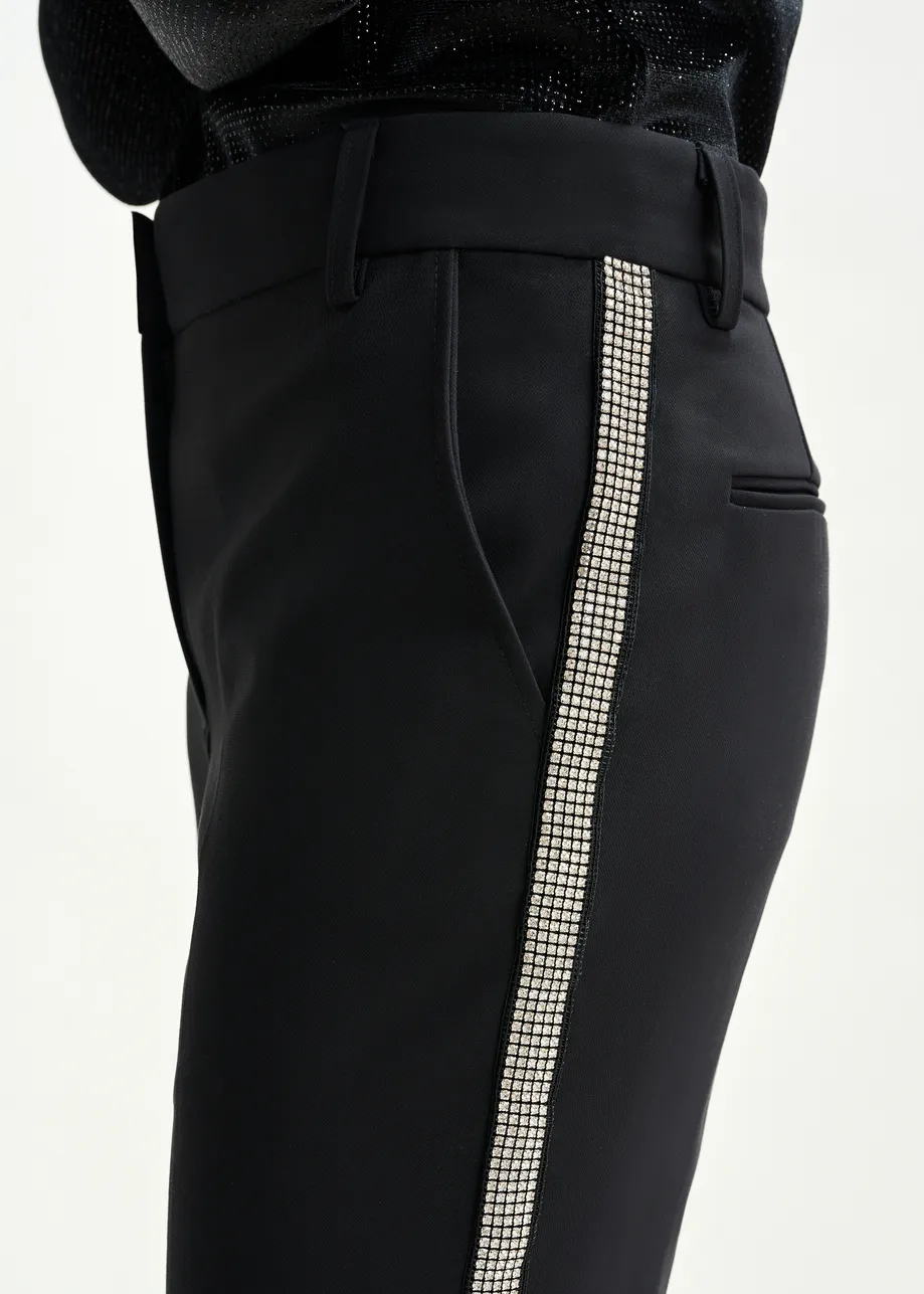 Black flared pants with rhinestone-embellished sideseams